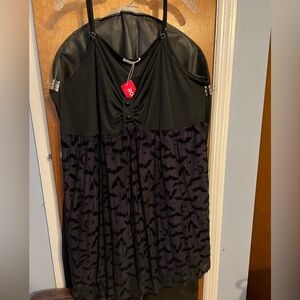 Black bat dress with purple lining.